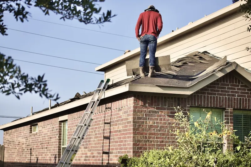 Professional roofer working on a residential roof in Fodor